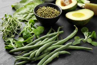 Photo of Superfood. Healthy food products on black table, closeup