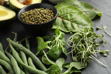 Photo of Superfood. Healthy food products on black table, closeup