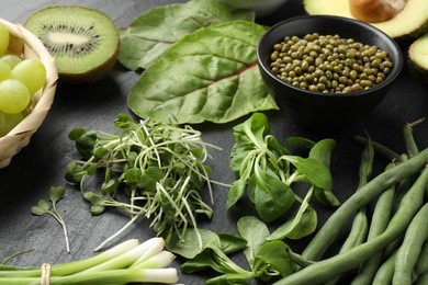 Photo of Superfood. Healthy food products on black table, closeup