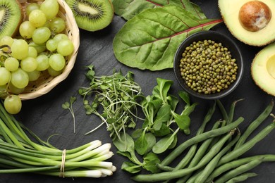 Photo of Superfood. Healthy food products on black table, flat lay