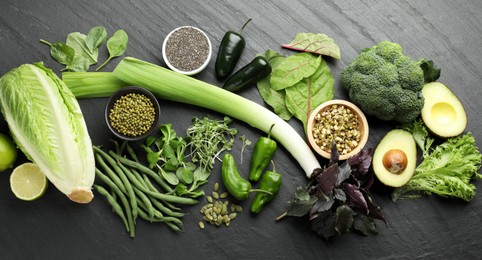 Photo of Superfood. Healthy food products on black table, flat lay