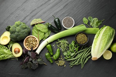Photo of Superfood. Healthy food products on black table, flat lay