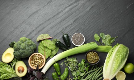 Photo of Superfood. Healthy food products on black table, flat lay. Space for text