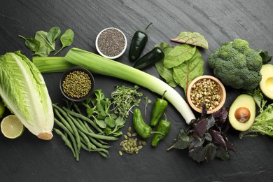Photo of Superfood. Healthy food products on black table, flat lay