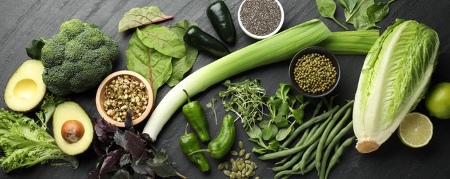 Photo of Superfood. Healthy food products on black table, flat lay