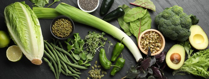 Photo of Superfood. Healthy food products on black table, flat lay