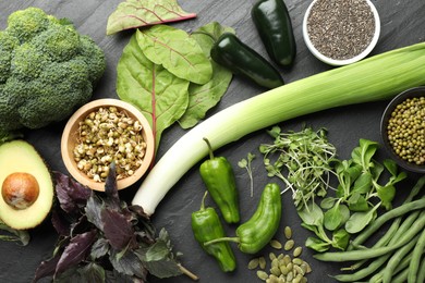 Photo of Superfood. Healthy food products on black table, flat lay
