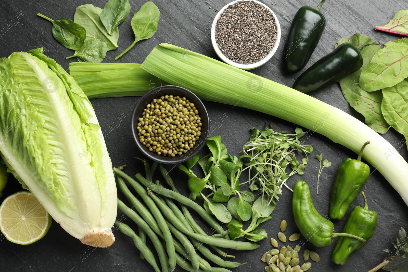 Photo of Superfood. Healthy food products on black table, flat lay