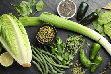 Photo of Superfood. Healthy food products on black table, flat lay