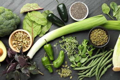 Photo of Superfood. Healthy food products on black table, flat lay