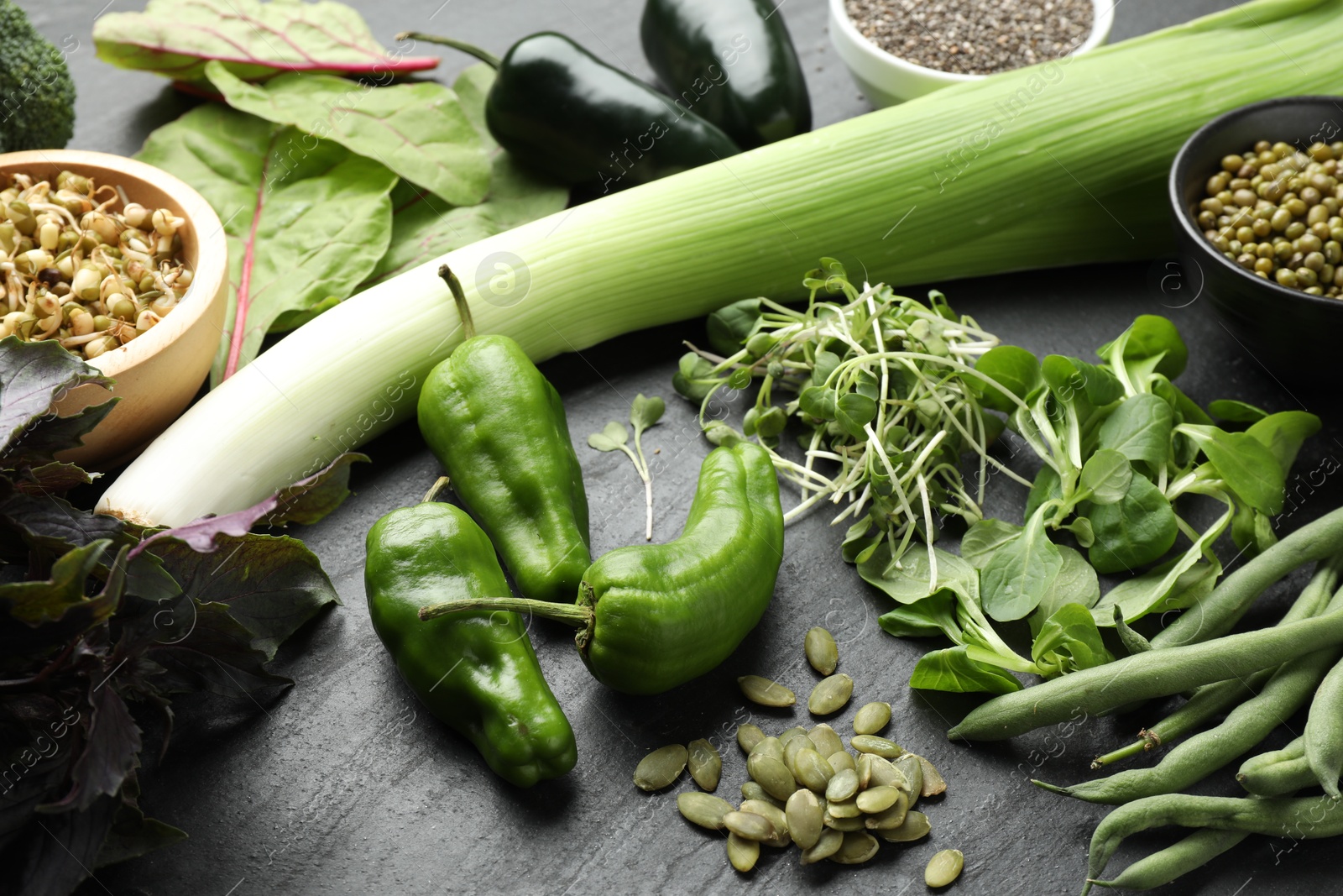 Photo of Superfood. Healthy food products on black table, closeup