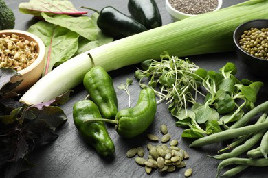 Photo of Superfood. Healthy food products on black table, closeup