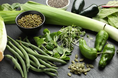 Photo of Superfood. Healthy food products on black table, closeup
