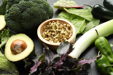 Photo of Superfood. Healthy food products on black table, closeup