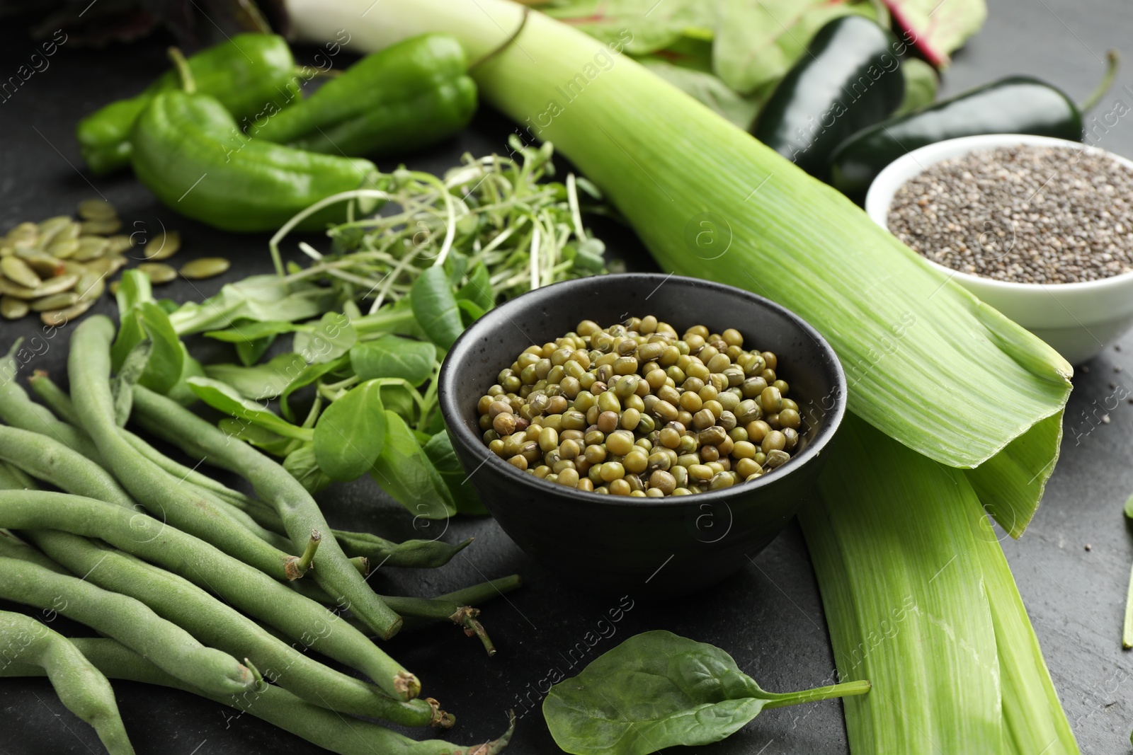 Photo of Superfood. Healthy food products on black table, closeup