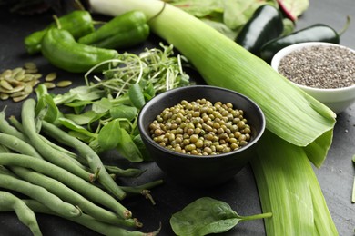 Photo of Superfood. Healthy food products on black table, closeup