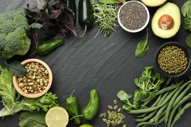Photo of Superfood. Healthy food products on black table, flat lay. Space for text