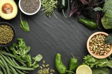 Photo of Superfood. Healthy food products on black table, flat lay. Space for text