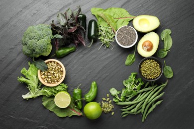 Photo of Superfood. Healthy food products on black table, flat lay. Space for text