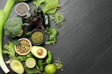 Photo of Superfood. Healthy food products on black table, flat lay. Space for text