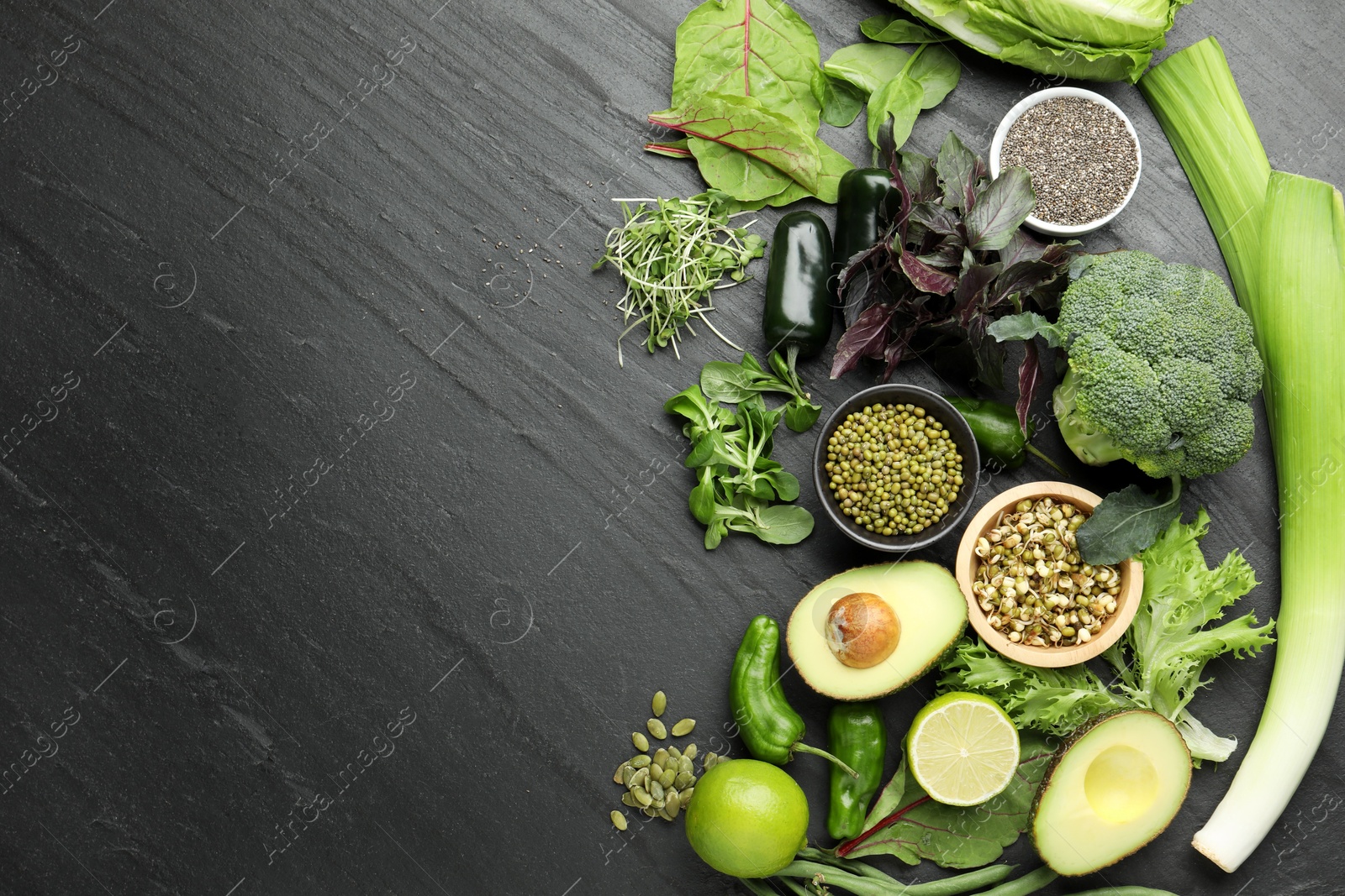 Photo of Superfood. Healthy food products on black table, flat lay. Space for text