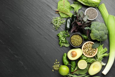 Photo of Superfood. Healthy food products on black table, flat lay. Space for text