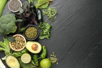 Photo of Superfood. Healthy food products on black table, flat lay. Space for text