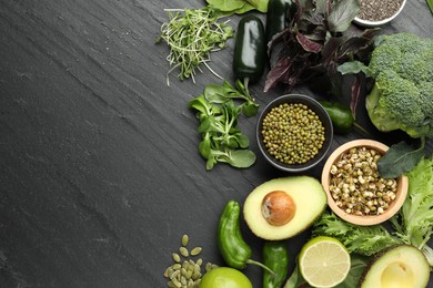 Photo of Superfood. Healthy food products on black table, flat lay. Space for text