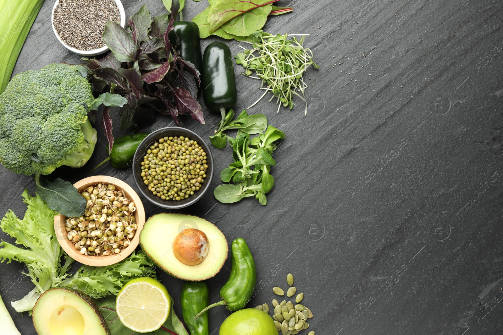 Superfood. Healthy food products on black table, flat lay. Space for text Photo of Superfood. Healthy food products on black table, flat lay. Space for text