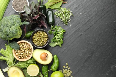 Photo of Superfood. Healthy food products on black table, flat lay. Space for text