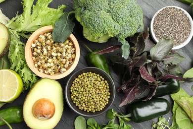 Photo of Superfood. Healthy food products on black table, flat lay