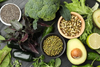 Photo of Superfood. Healthy food products on black table, flat lay