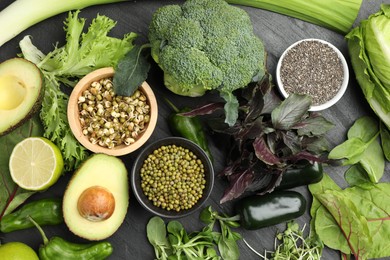 Photo of Superfood. Healthy food products on black table, flat lay