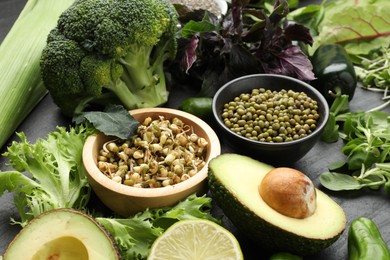 Photo of Superfood. Healthy food products on black table, closeup