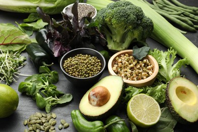 Photo of Superfood. Healthy food products on black table, closeup