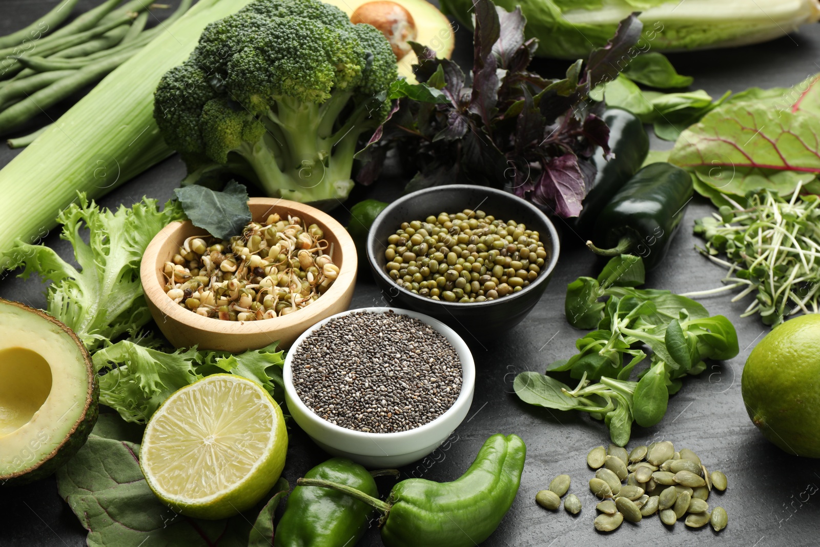 Photo of Superfood. Healthy food products on black table, closeup