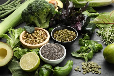 Photo of Superfood. Healthy food products on black table, closeup