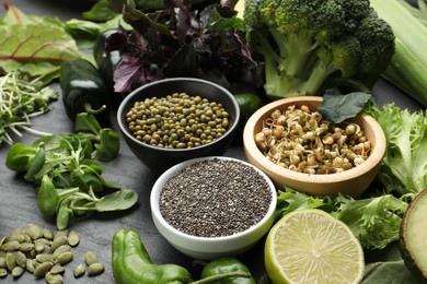 Photo of Superfood. Healthy food products on black table, closeup