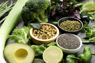 Photo of Superfood. Healthy food products on black table, closeup