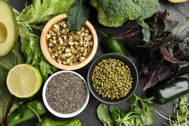 Photo of Superfood. Healthy food products on black table, flat lay