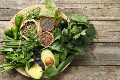 Photo of Superfood. Healthy food products on wooden table, top view. Space for text