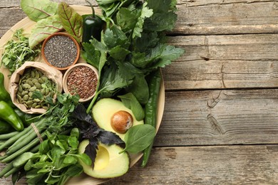 Photo of Superfood. Healthy food products on wooden table, top view. Space for text