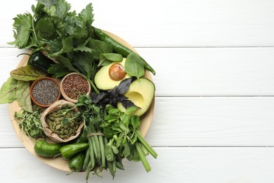 Photo of Superfood. Healthy food products on white wooden table, top view. Space for text