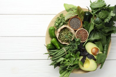 Photo of Superfood. Healthy food products on white wooden table, top view. Space for text