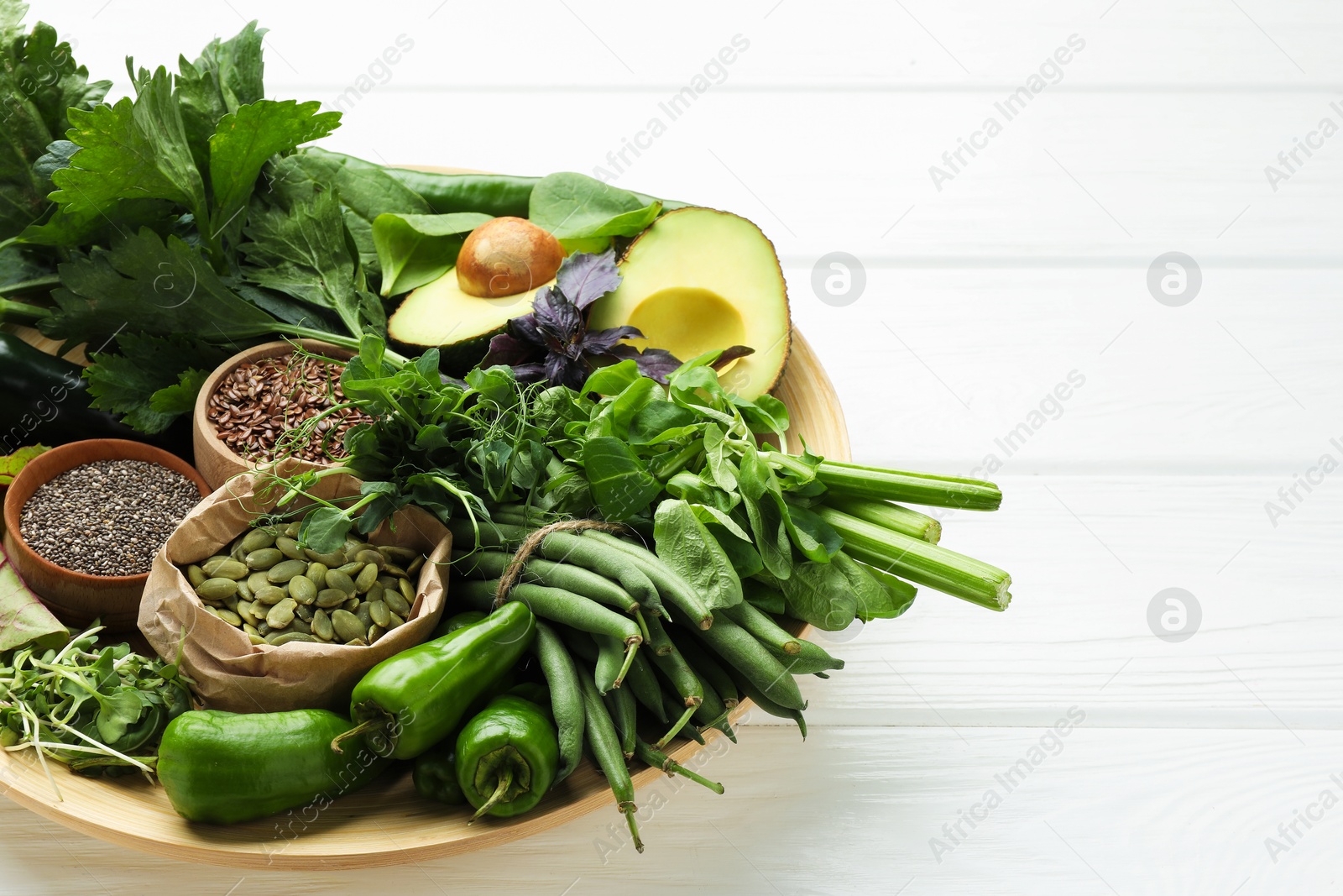 Photo of Superfood. Healthy food products on white wooden table, closeup. Space for text