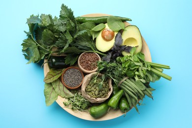 Photo of Superfood. Healthy food products on light blue background, flat lay