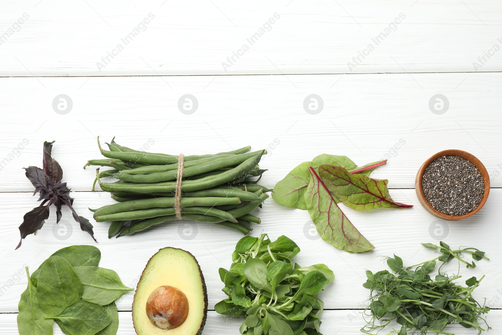 Photo of Superfood. Healthy food products on white wooden table, flat lay. Space for text