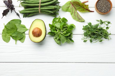 Photo of Superfood. Healthy food products on white wooden table, flat lay. Space for text