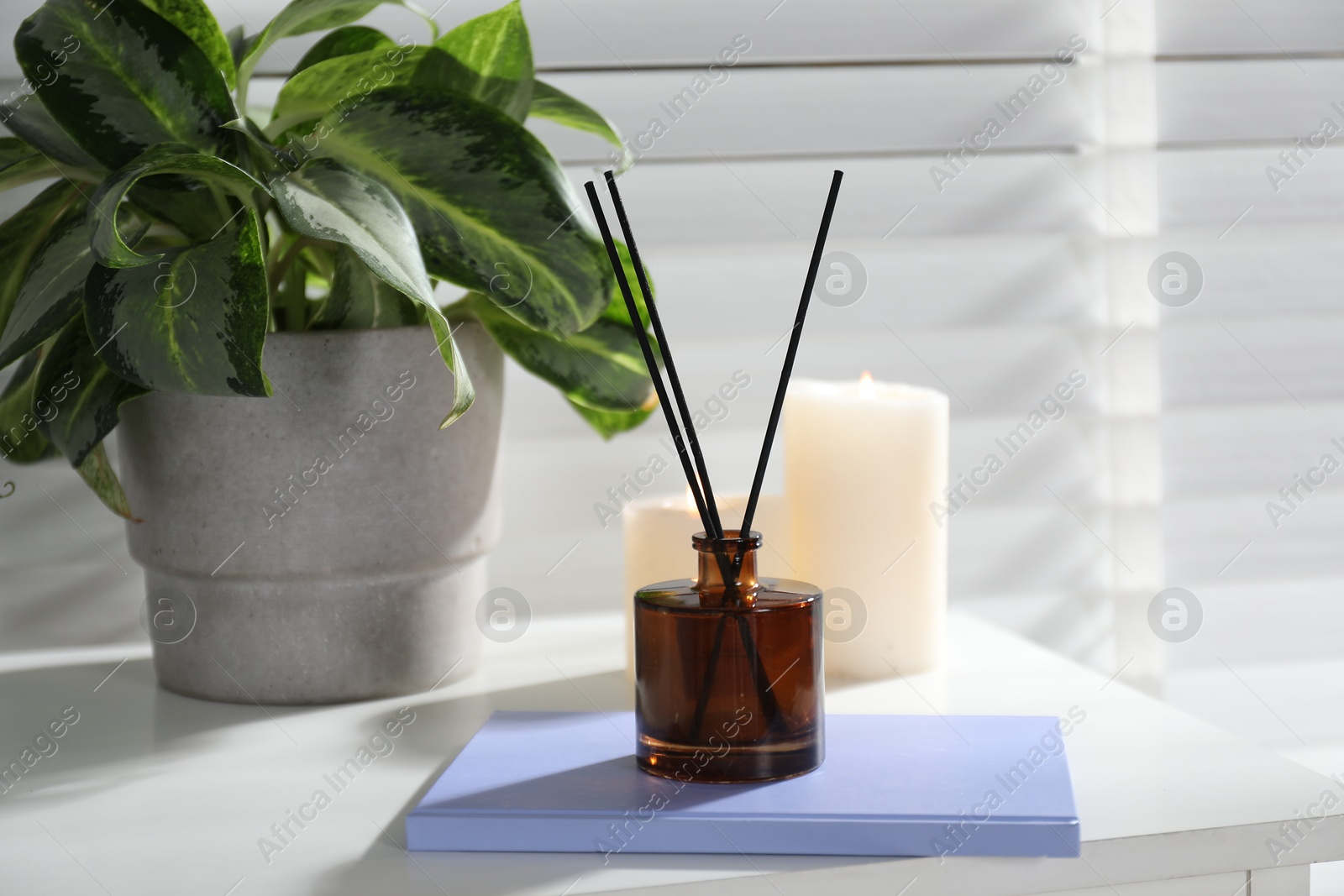 Spa composition with reed air freshener on white table indoors, closeup Photo of Spa composition with reed air freshener on white table indoors, closeup