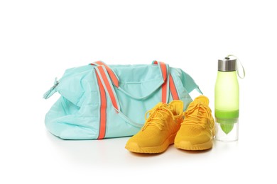 Photo of Stylish sports bag, bottle and sneakers isolated on white